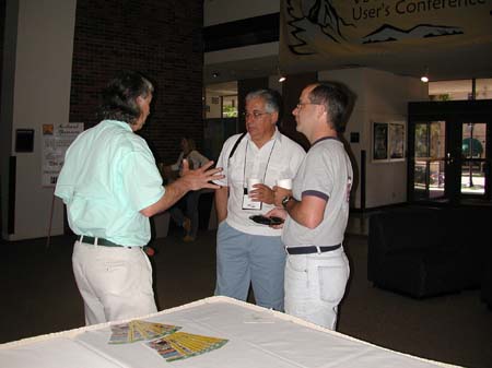 Mike Cline, Luis Lloréns, and Peter Hoyt discuss OpenScript during a break